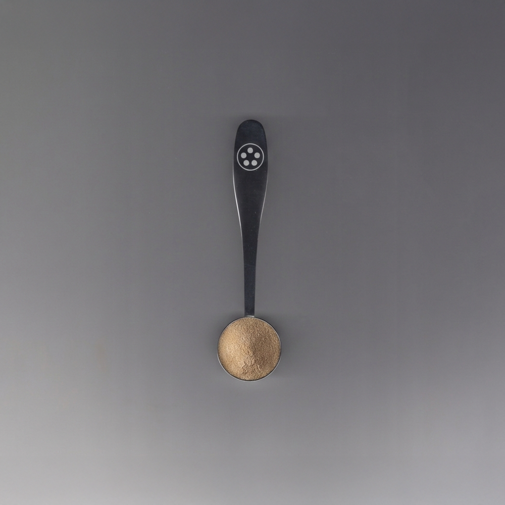 matter wellness Spoon with a silver handle on a gray background